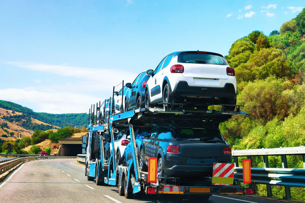 Cars on a transporter on a country road