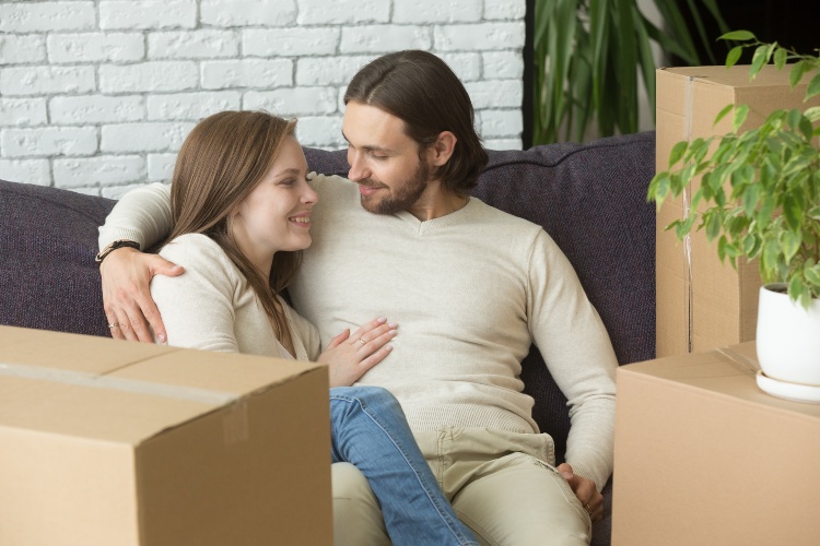 Couple on Sofa by Moving Boxes
